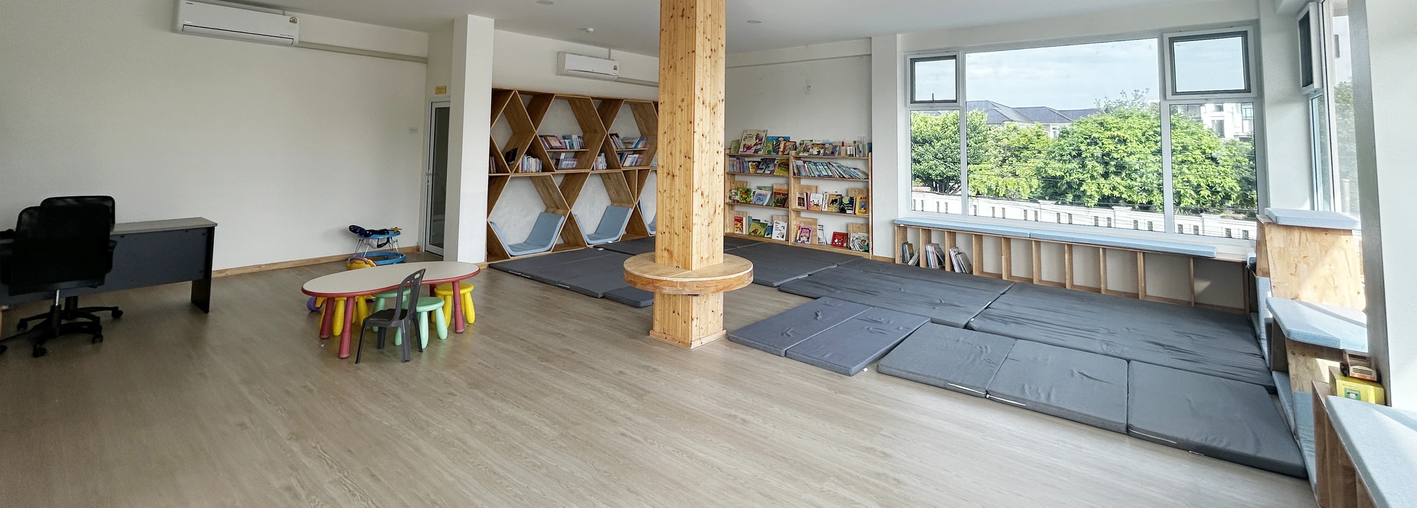 The SiLA Library room, with its geometric wooden shelving and a bright reading window